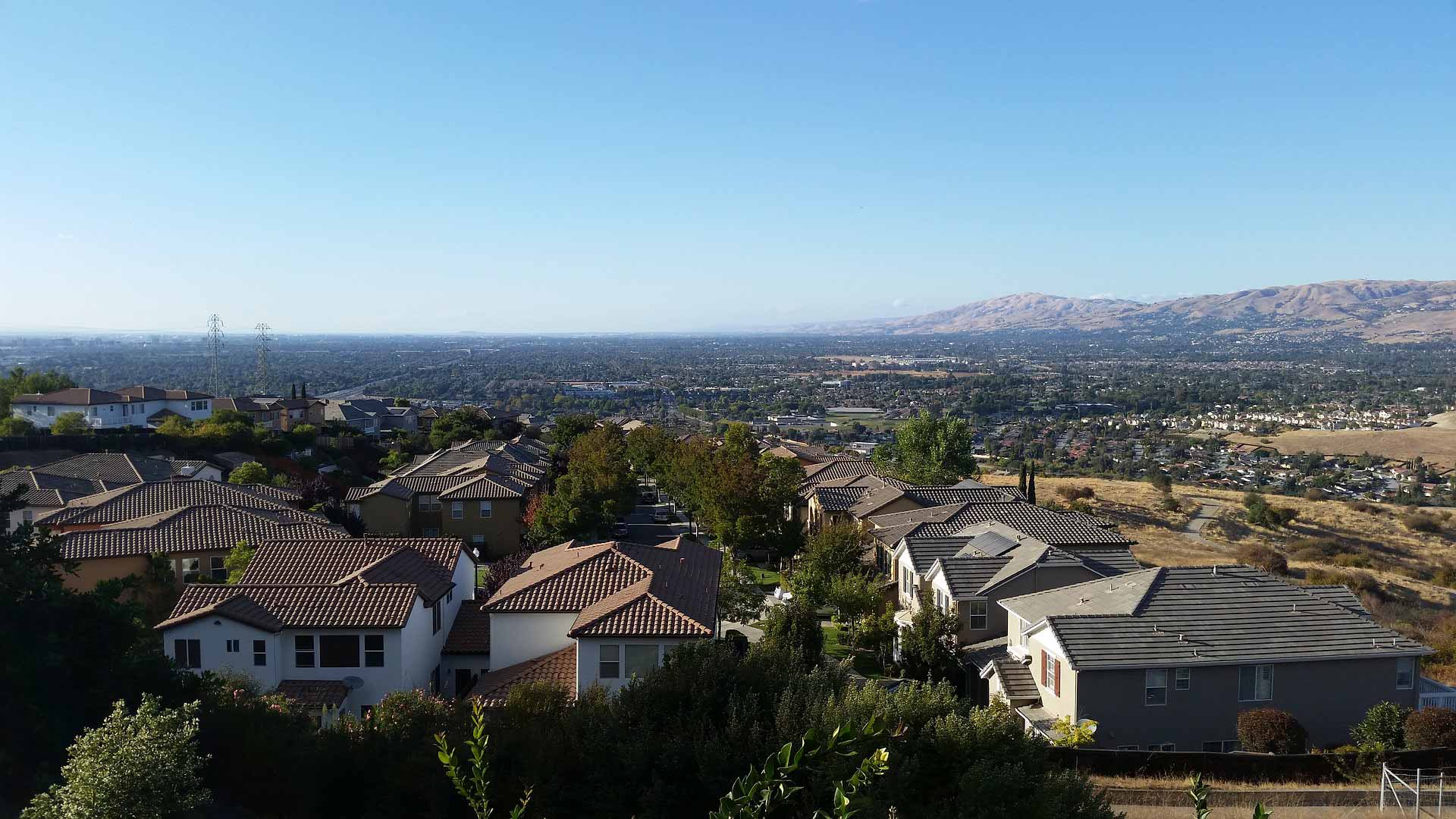 A bird's-eye of a neighborhood filled with mission-style single-family homes.
